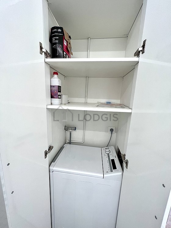 Bathroom equipped with washing machine, cupboard