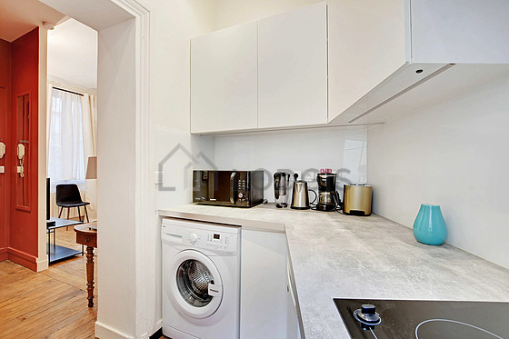 Kitchen equipped with hob, refrigerator