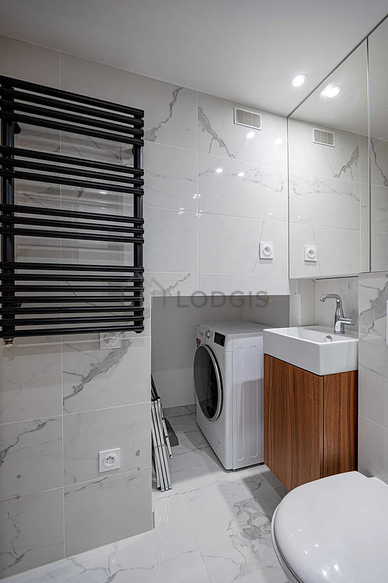 Bathroom equipped with washing machine, bath towels