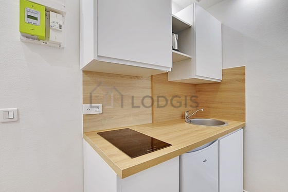 Kitchen equipped with hob, refrigerator