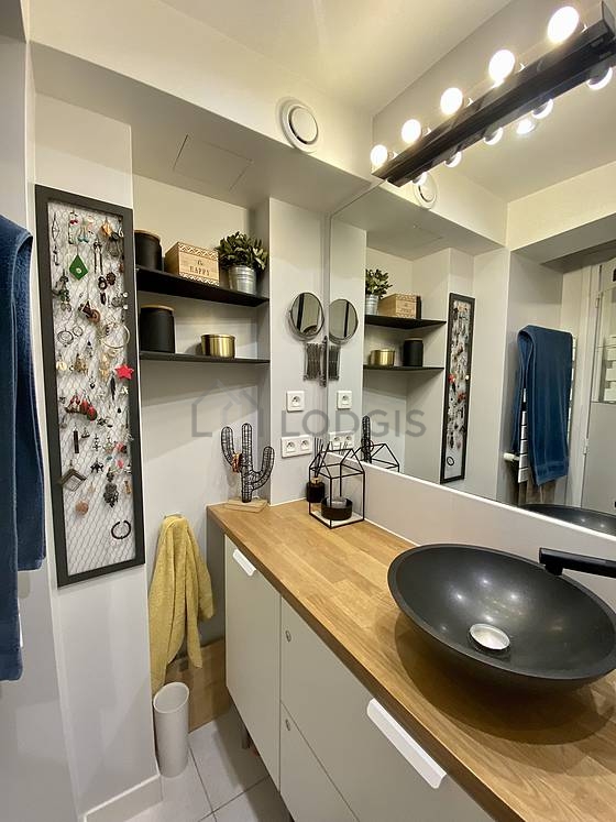Bathroom equipped with washing machine, dryer, shelves