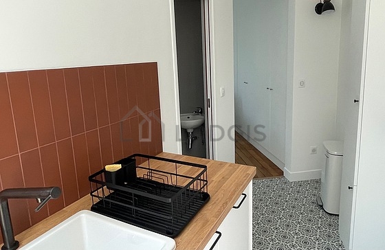 Kitchen equipped with washing machine, refrigerator, extractor hood, crockery