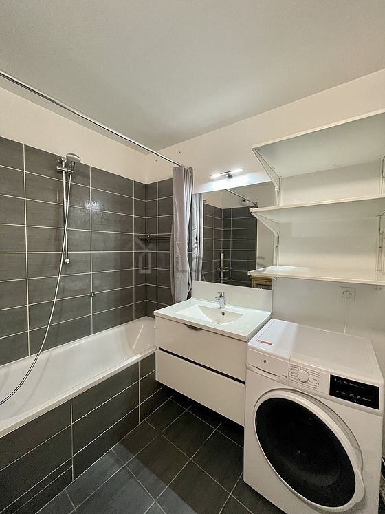 Bathroom equipped with washing machine, shelves