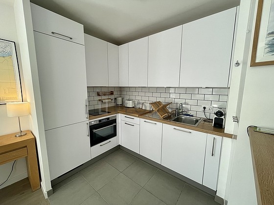 Kitchen equipped with dishwasher, hob, refrigerator, extractor hood