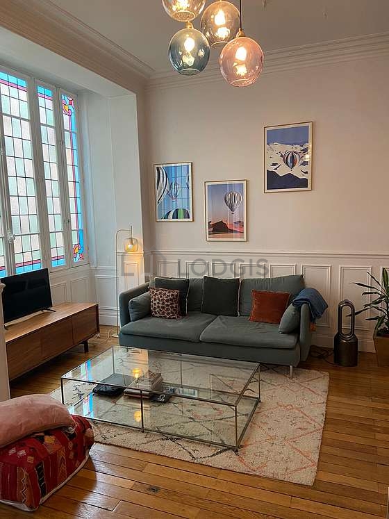 Living room furnished with tv, fan, 1 armchair(s), 1 chair(s)