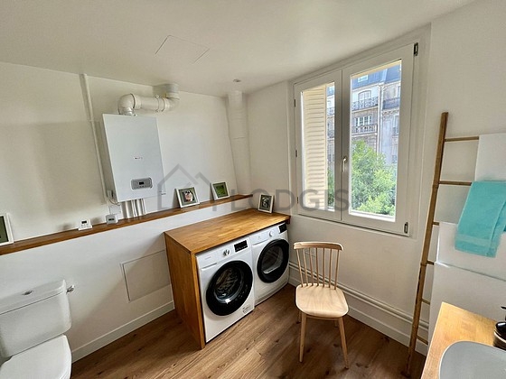 Bathroom equipped with washing machine, dryer, cupboard