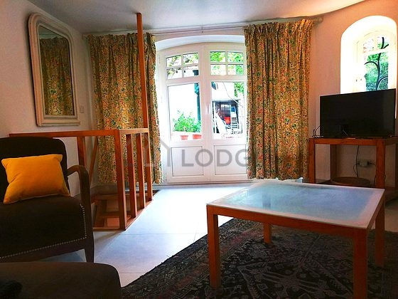 Living room furnished with tv, fan, 1 armchair(s), 1 chair(s)