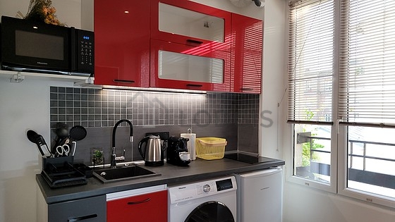 Kitchen equipped with washing machine, refrigerator, crockery