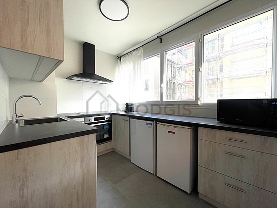 Kitchen equipped with washing machine, refrigerator, extractor hood, crockery