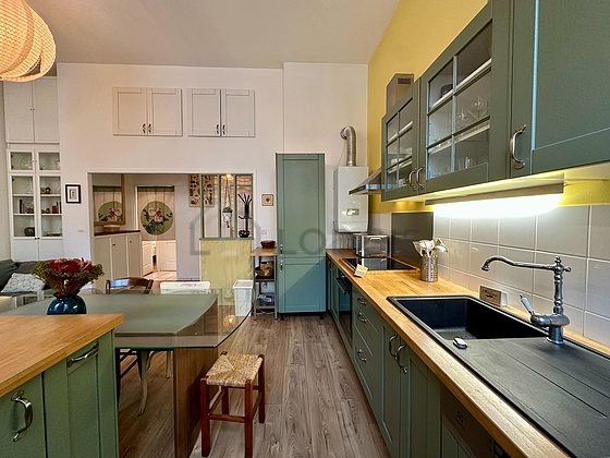 Kitchen equipped with hob, extractor hood