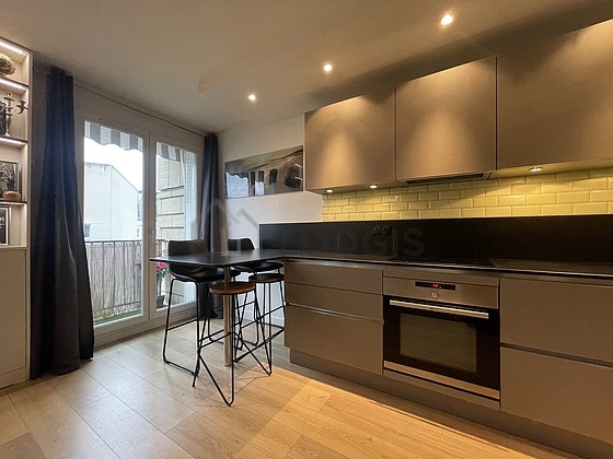 Kitchen equipped with dishwasher, hob, refrigerator, extractor hood