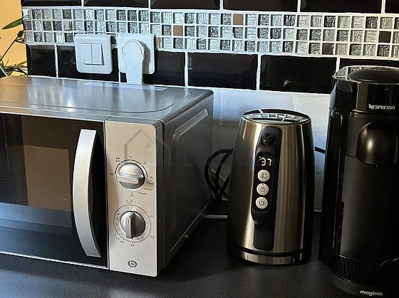 Kitchen equipped with washing machine, dryer, refrigerator, crockery