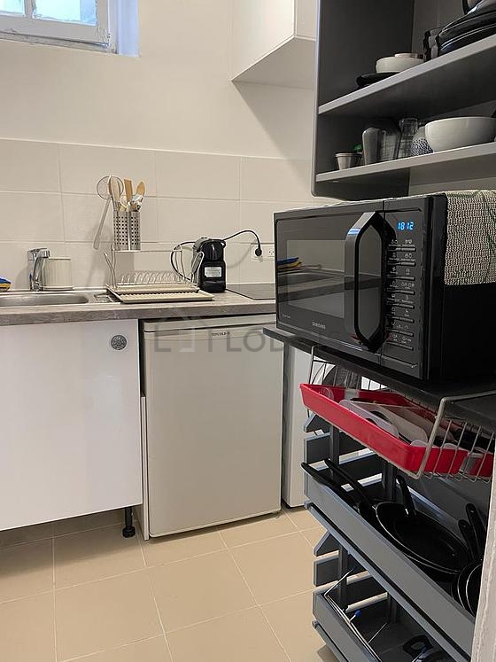 Kitchen equipped with washing machine, refrigerator, crockery
