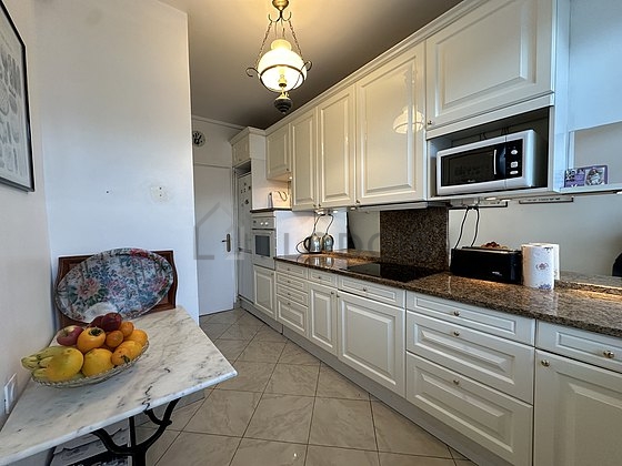 Kitchen equipped with dishwasher, hob, refrigerator, extractor hood