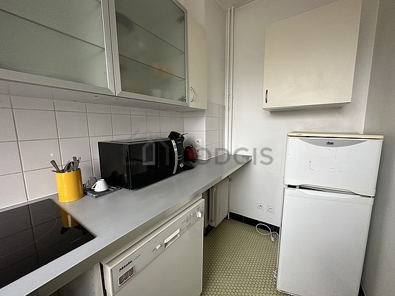 Kitchen equipped with dishwasher, hob, refrigerator, crockery