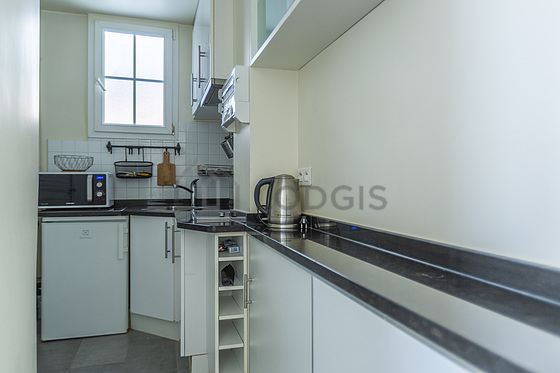 Kitchen equipped with washing machine, refrigerator, freezer, extractor hood