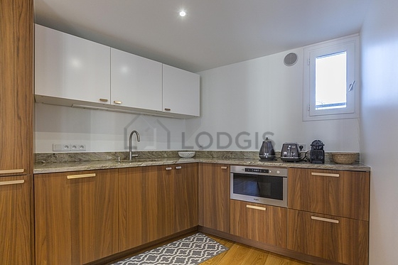 Kitchen equipped with dishwasher, hob, refrigerator, extractor hood