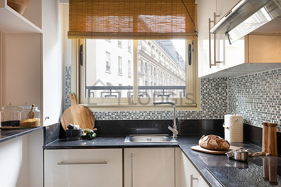 Kitchen equipped with washing machine, refrigerator, crockery