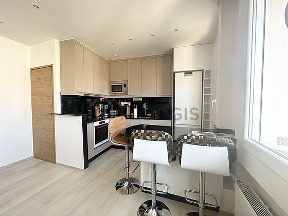 Kitchen equipped with dishwasher, hob, refrigerator, extractor hood