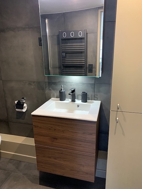 Bathroom equipped with washing machine, dryer, bath towels