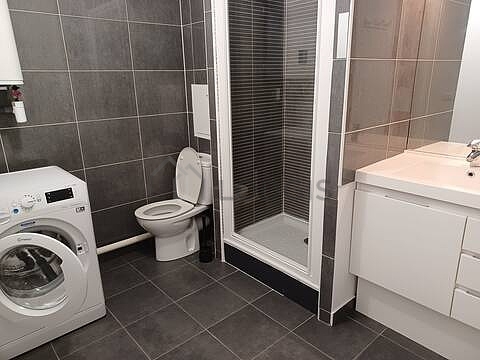 Bathroom equipped with washing machine, separate shower