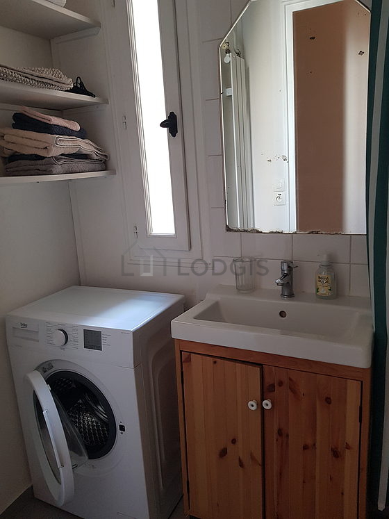 Bathroom equipped with washing machine, shelves