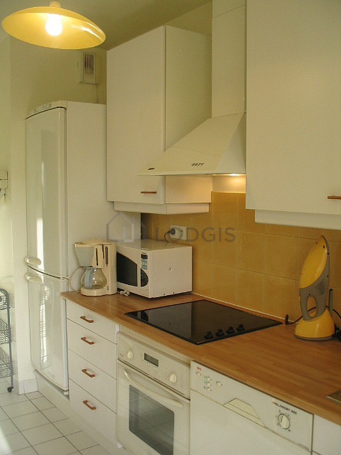 Bright kitchen with windows and balcony facing the garden