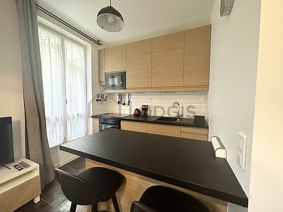 Kitchen where you can have dinner for 2 person(s) equipped with hob, refrigerator, freezer, crockery