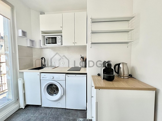 Kitchen equipped with washing machine, refrigerator, freezer, crockery