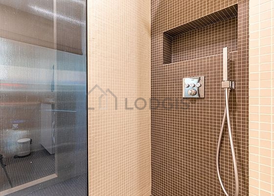Bathroom equipped with washing machine, separate shower