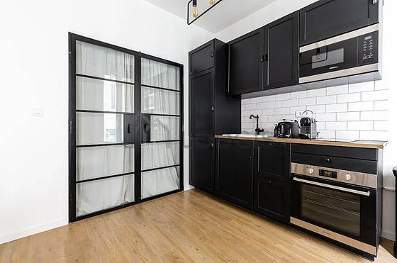 Kitchen equipped with dishwasher, hob, refrigerator, extractor hood