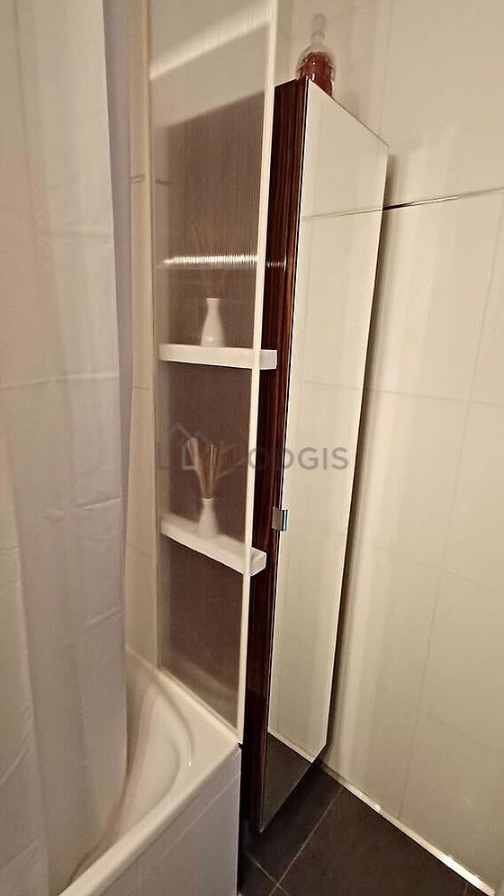 Bathroom equipped with washing machine, cupboard