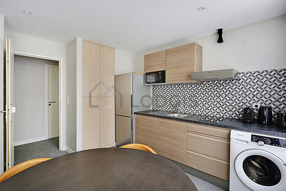 Kitchen equipped with washing machine, refrigerator, extractor hood, crockery