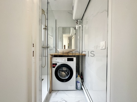 Bathroom equipped with washing machine, separate shower
