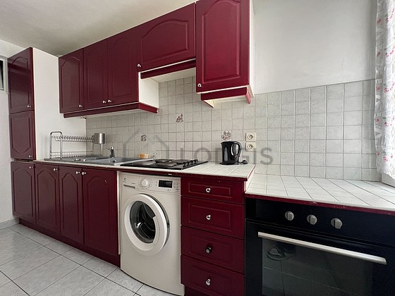 Kitchen equipped with washing machine, refrigerator, crockery