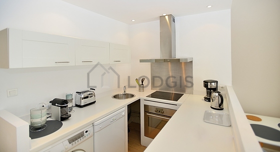 Kitchen equipped with washing machine, refrigerator, crockery