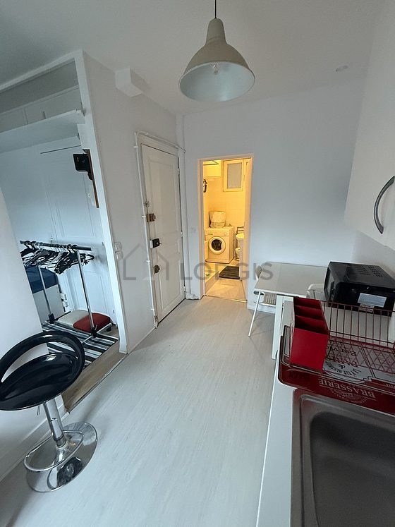 Kitchen equipped with hob, refrigerator, freezer, crockery