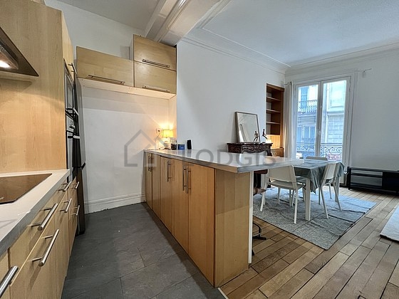 Kitchen equipped with dishwasher, hob, refrigerator, extractor hood