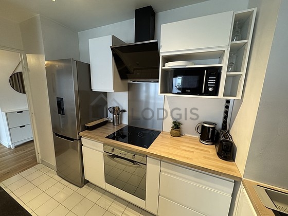Kitchen equipped with dishwasher, hob, refrigerator, extractor hood