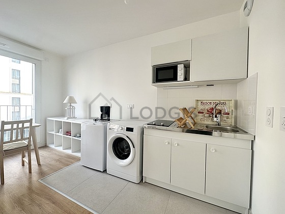 Kitchen equipped with washing machine, refrigerator, freezer, crockery