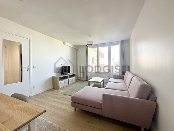 Quiet living room furnished with tv, cupboard, 1 chair(s)