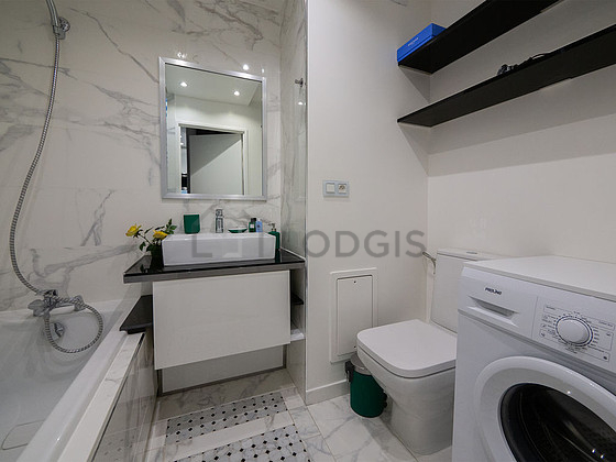 Bathroom equipped with washing machine, shelves