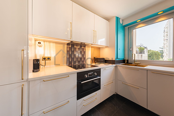 Kitchen equipped with dishwasher, hob, refrigerator, crockery