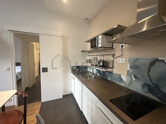 Kitchen equipped with washing machine, refrigerator, freezer, extractor hood