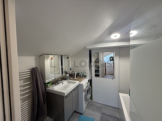 Bathroom equipped with washing machine, bath tub