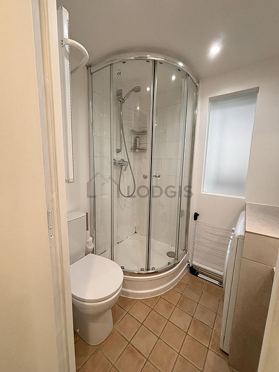 Bathroom equipped with washing machine, dryer, bath towels