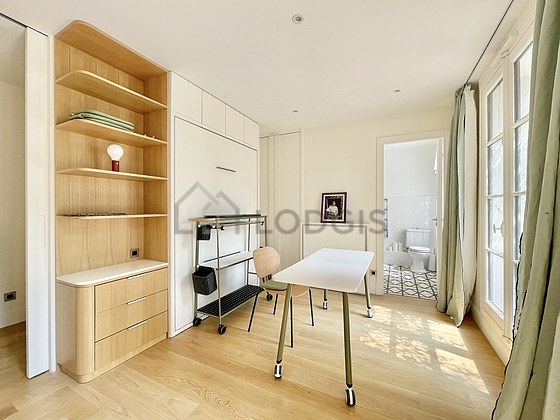 Very bright bedroom equipped with desk, wardrobe, cupboard