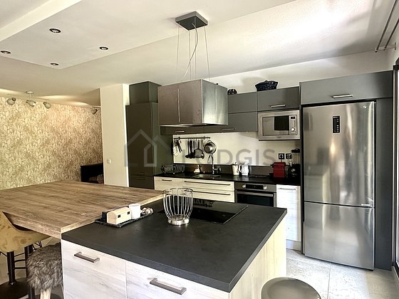 Kitchen equipped with washing machine, refrigerator, extractor hood, crockery