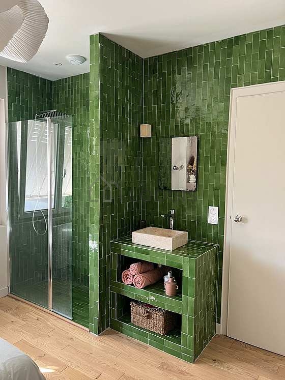Pleasant and very bright bathroom with wooden floor
