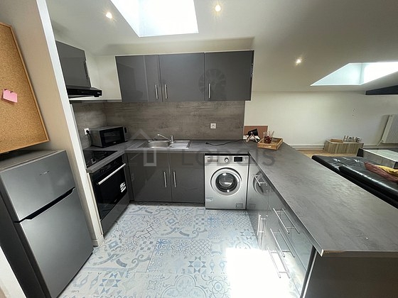 Kitchen equipped with washing machine, refrigerator, crockery